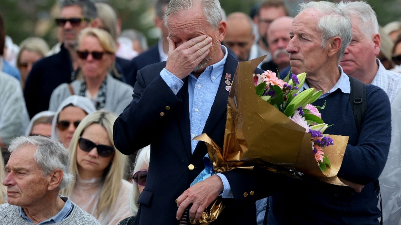 People attend a commemoration ceremony to mark the 20th anniversary of the Bali bombings at Sydney's Coogee Beach 