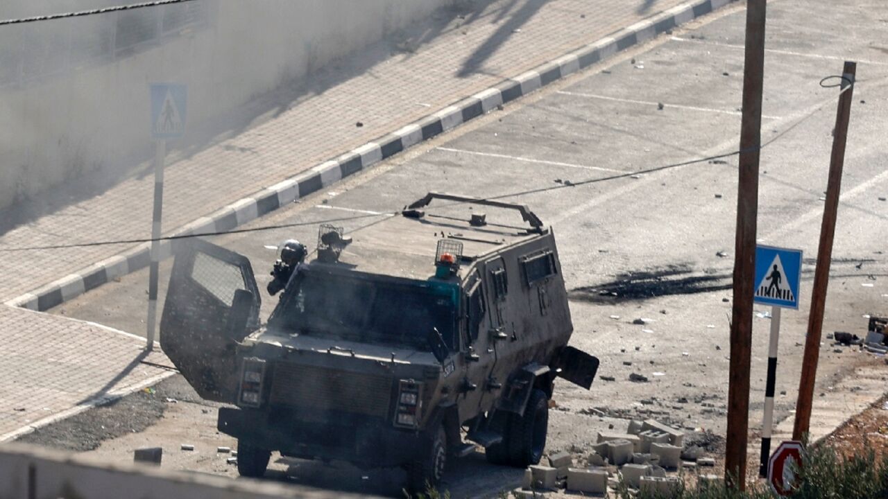 Israeli troops fire tear gas in the West Bank village of Deir al-Hatab during clashes in which one Palestinian was killed on October 5