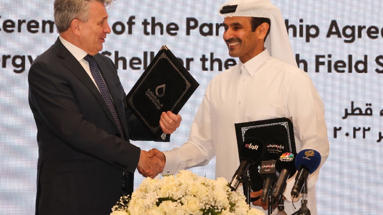 Qatar's Minister of State for Energy Affairs and President and CEO of QatarEnergy Saad Sherida al-Kaabi (R) and Shell’s CEO Ben van Beurden hold a signing ceremony at QatarEnergy headquarters in Doha, on October 23