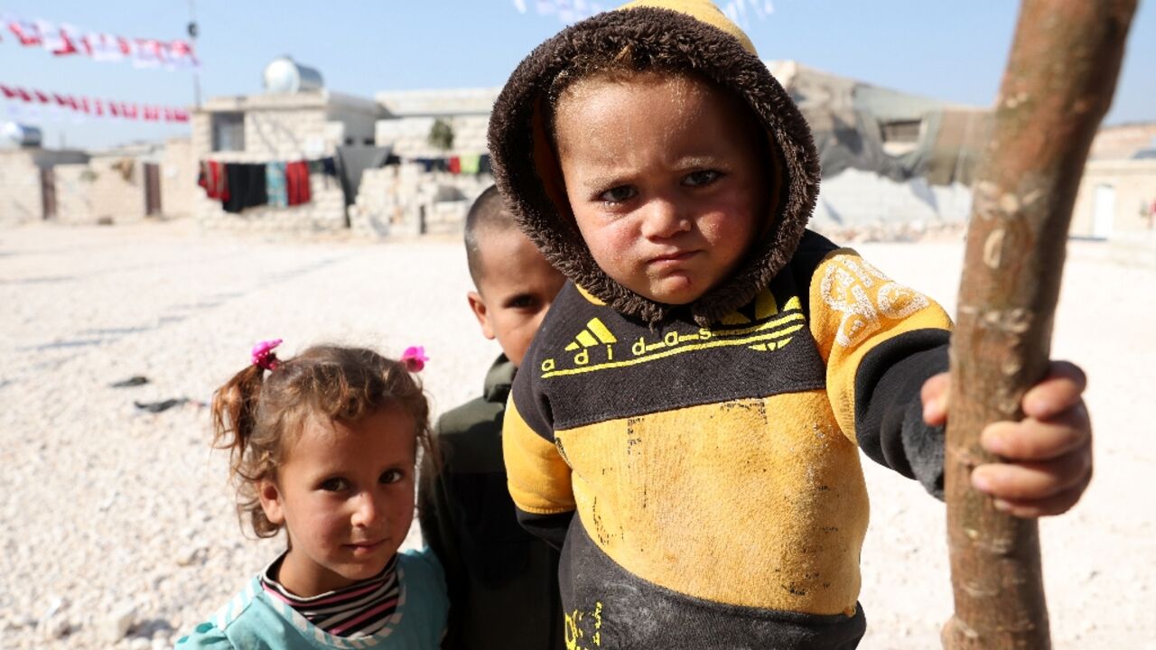 Displaced Syrians are pictured at a newly built housing complex constructed with Turkish support at Mashhad Ruhin,  in the Syrian rebel-held northwestern province of Idlib