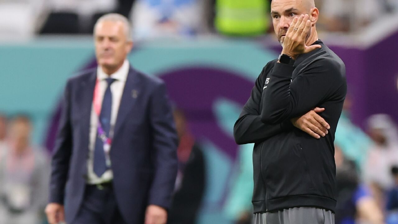 Qatar's Spanish coach Felix Sanchez (R) watched from the touchline