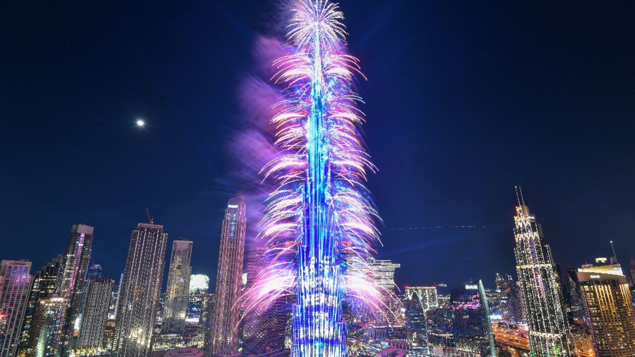 New Year's Eve fireworks light the landmark Burj Khalifa tower at midnight in the Gulf emirate of Dubai on December 31, 2022