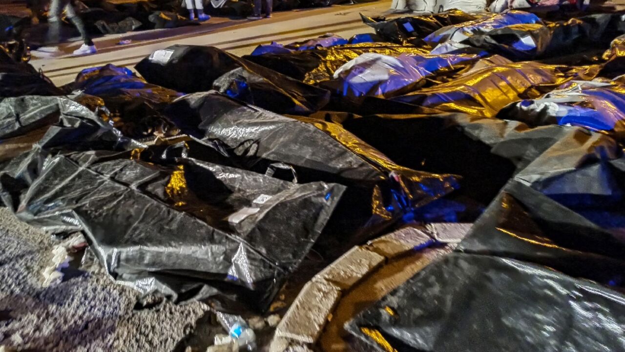 In the parking lot of the main hospital in Antakya survivors were going from corpse to corpse looking for people they knew