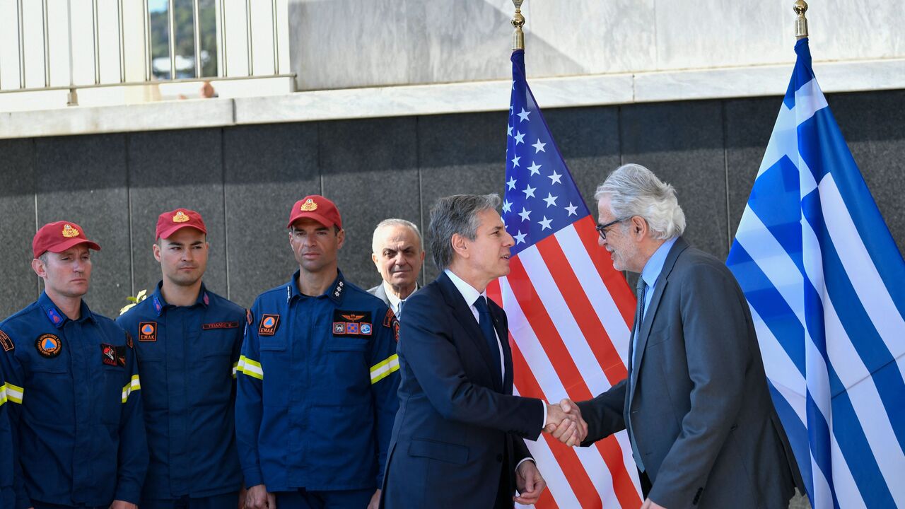 Greece's Minister for the Climate Crisis and Civil Protection Christos Stylianides (R) shakes hands with US Secretary of State Antony Blinken (C) during a meeting with a Search and Rescue team that assisted during the earthquake in Turkey, in Athens, on February 21, 2023. (Photo by MICHAEL VARAKLAS/POOL/AFP via Getty Images)