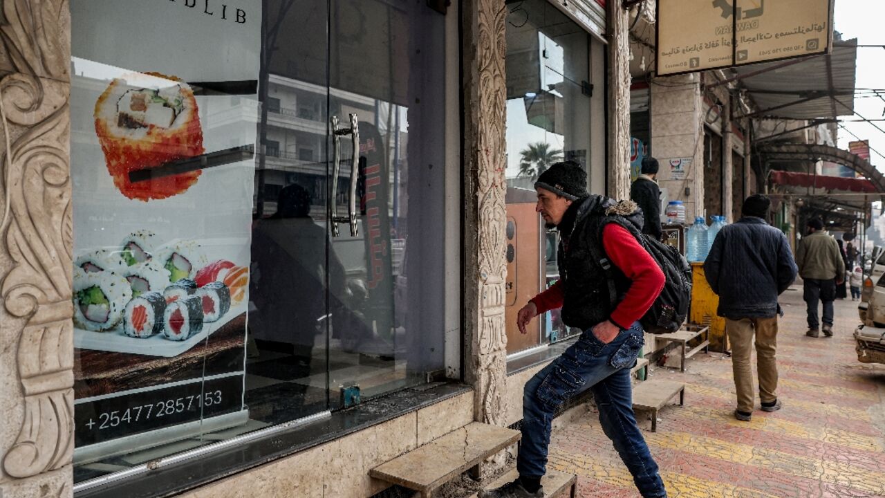 Islam Shakhbanov arrives at his sushi restaurant in Syria's rebel-held northwestern city of Idlib