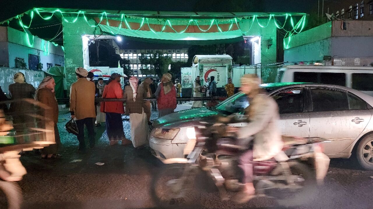 Yemenis wait outside a hospital after the stampede