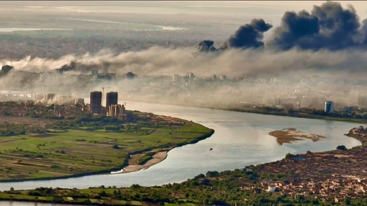 This video grab taken from AFPTV video footage on April 19, 2023, shows an aerial view of black smoke covering the sky above the capital Khartoum