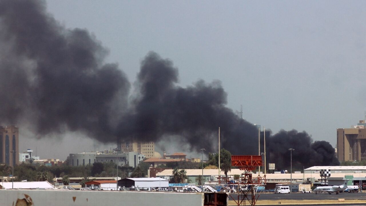 Heavy smoke billows over Khartoum airport where the Sudanese army accuses a rival paramilitary force of setting fire to civilian aircraft