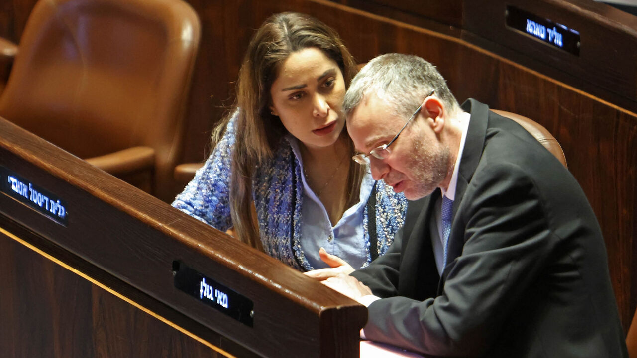 Israeli Justice Minister Yariv Levin (R) listens to MP May Golan during a session at the Knesset, Jerusalem, March 20, 2023.