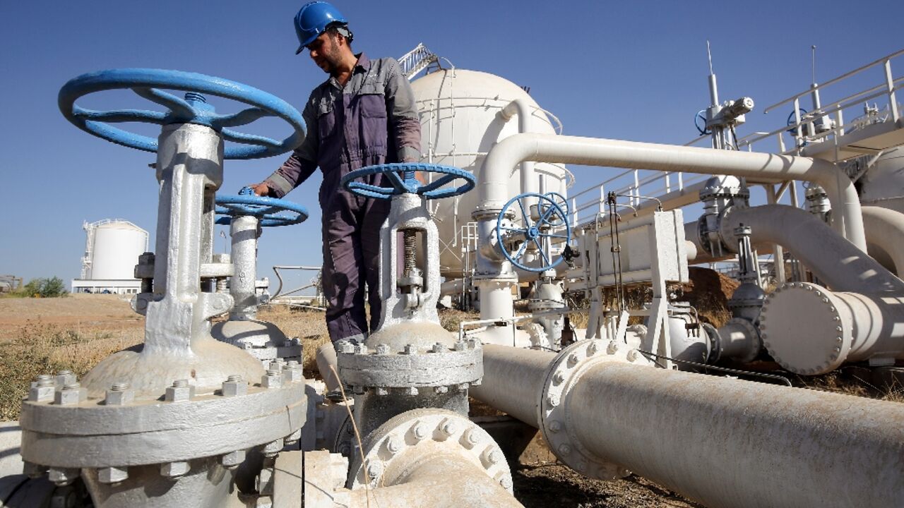 An Iraqi oil employee checks pipelines at the Bai Hassan oil field, west of the northern Iraqi city of Kirkuk in 2017