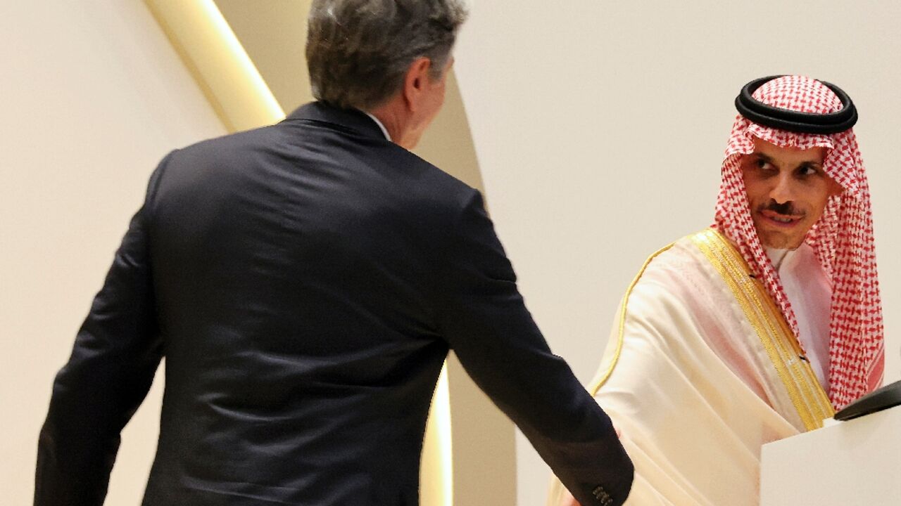 US Secretary of State Antony Blinken  approaches to shake the hand of Saudi Foreign Minister Faisal bin Farhan during a joint press conference in Riyadh 