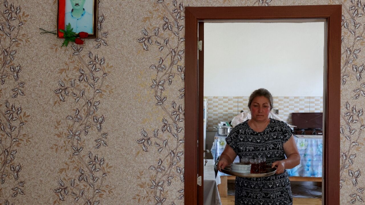 Widow Nazakat Valiyeva, an Azeri refugee from Nagorno-Karabakh, with a picture of her husband who was killed by shelling in 2020