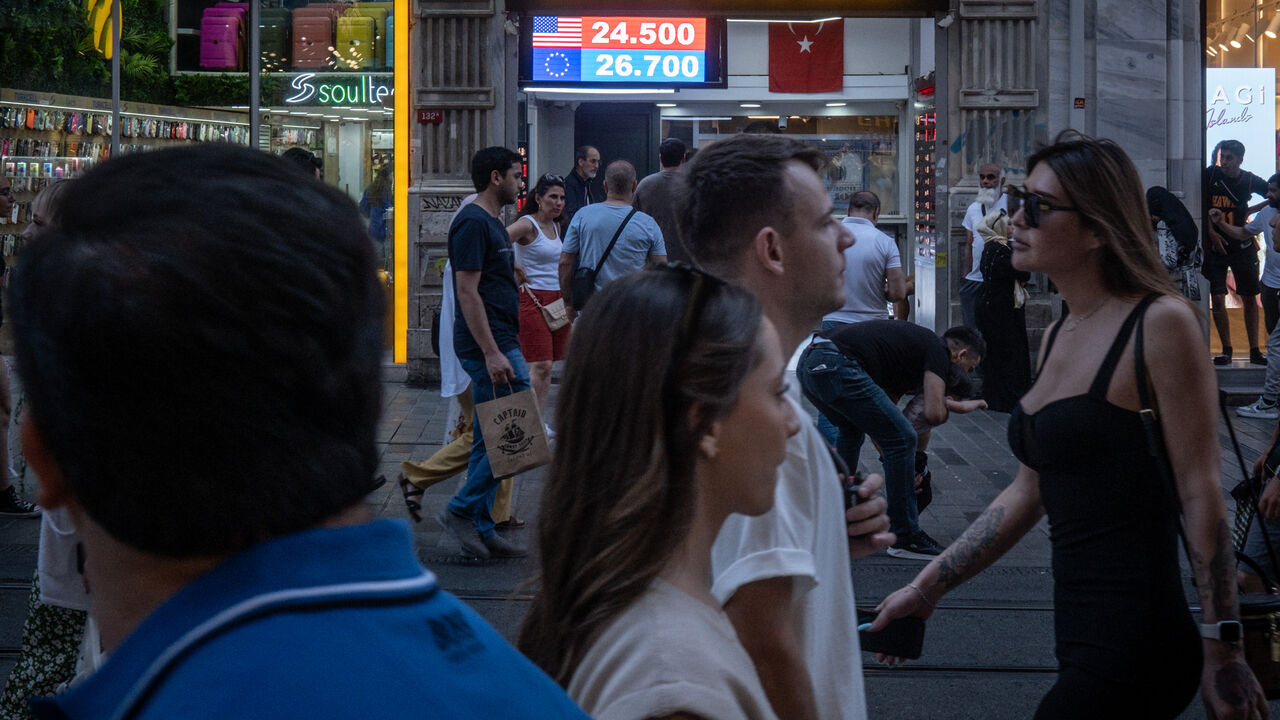 People walk past a currency exchange shop on June 23, 2023 in Istanbul, Turkey. The Turkish Lira weakened to a record low of 25.74 against the dollar, a day after the central bank hiked interest rates from 8.5 percent to 15 percent in the first rate decision since the appointment of new central bank governor Hafize Gaye Erkan and the re-election of President Recep Tayyip Erdogan last month. (Photo by Chris McGrath/Getty Images)