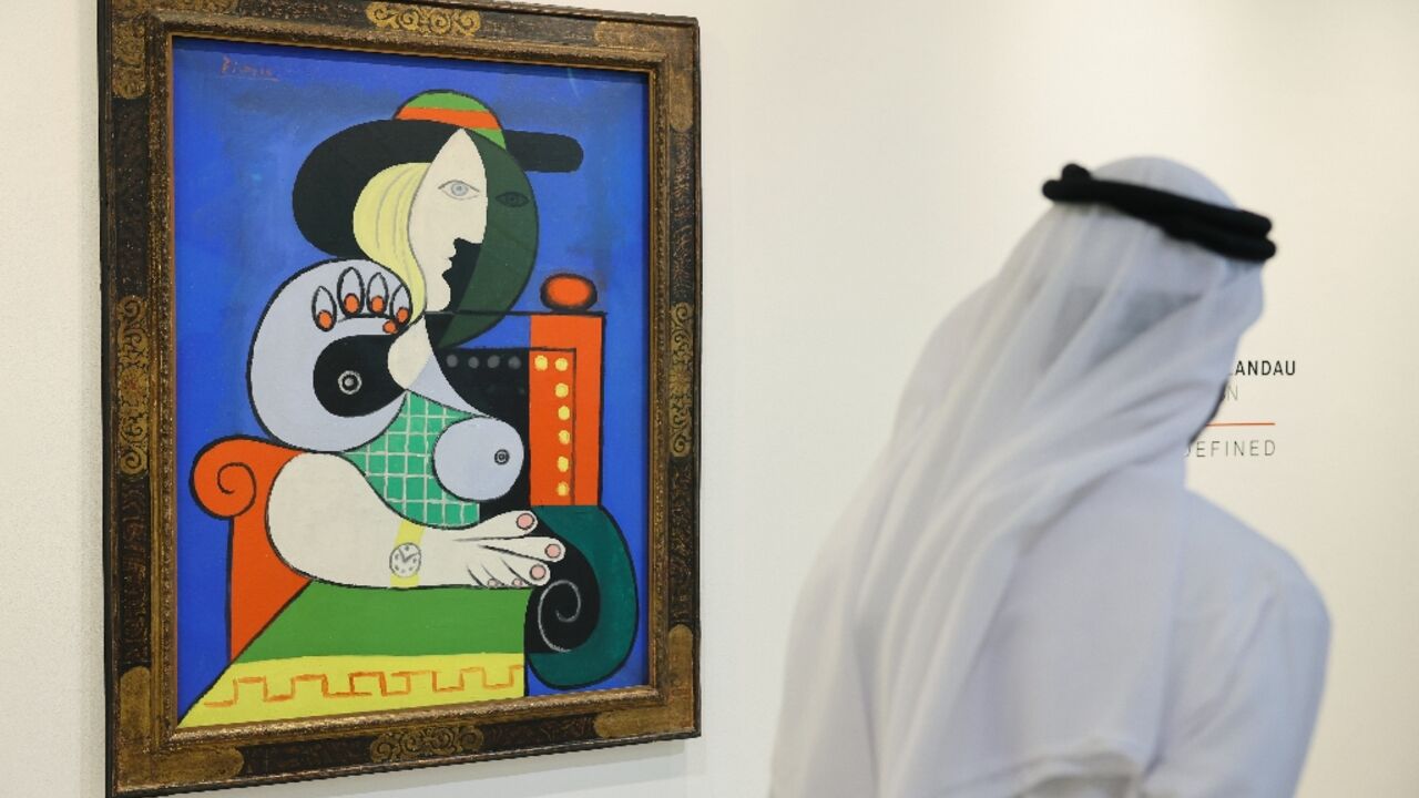 A visitor looks at Pablo Picasso's painting 'Femme a la montre' displayed for viewing at Sotheby’s Dubai, ahead of an auction in New York