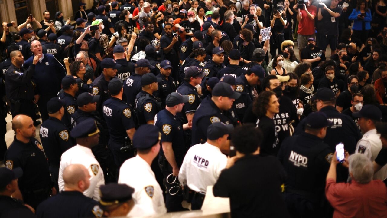 NYPD officers move in on a sit-in organised by Jewish groups calling for a ceasefire in the Israel-Hamas war, at Grand Central station in New York City