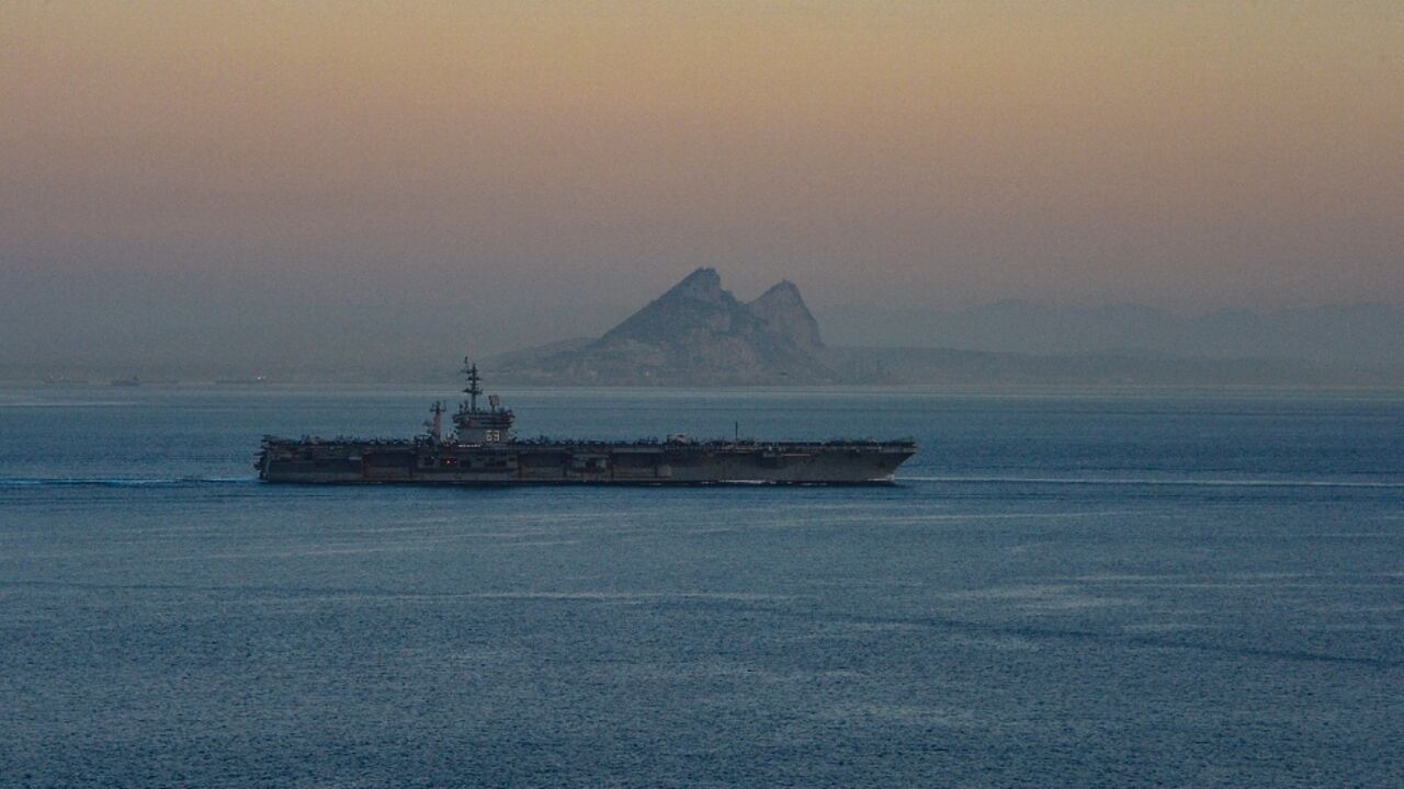 A photo obtained from the US Department of Defense shows the USS Dwight D. Eisenhower aircraft carrier transiting the Strait of Gibraltar on October 28, 2023