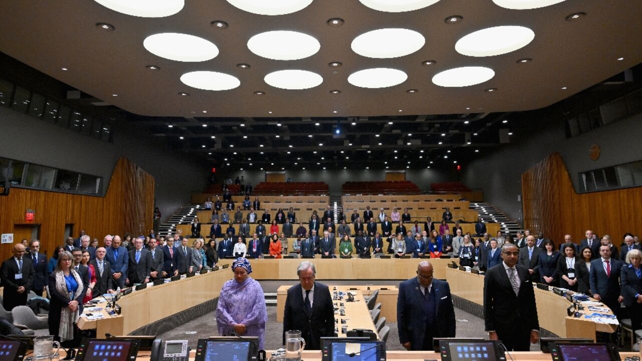 At United Nations headquarters, (L-R) UN Deputy Secretary-General Amina Mohammed, UN Secretary-General Antonio Guterres and others observe a minute of silence in memory of colleagues killed in Gaza during the Israel-Hamas conflict