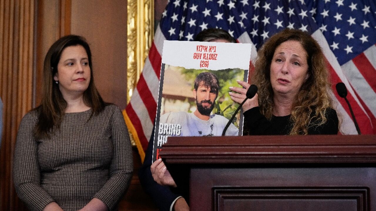 Doris Liber holds up a photo of her son, Guy Iluz, who was kidnapped by Hamas, during a news conference at the US Capitol