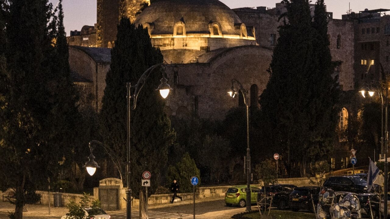 A man runs for cover in Jerusalem as sirens warning of incoming rocket fire from Gaza blare in the city for the first time since October 30