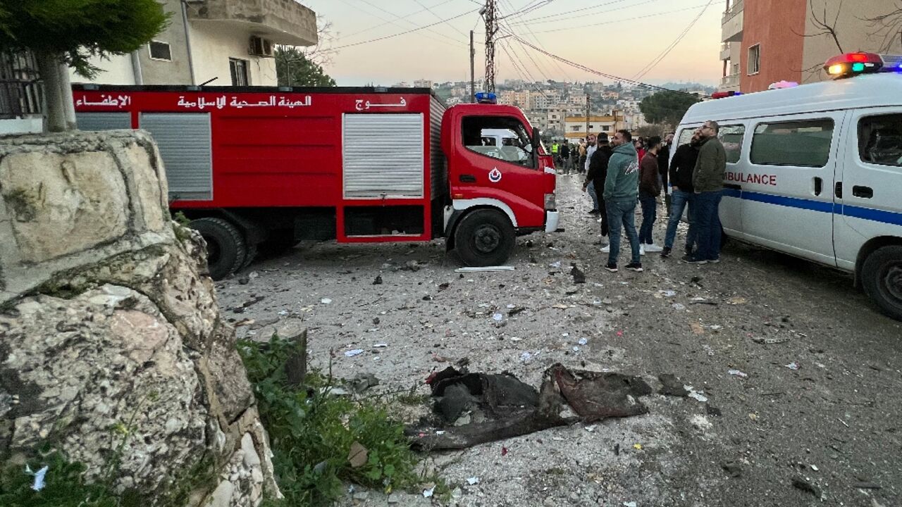 Lebanese emergency services respond to an Israeli drone strike which killed two Hezbollah fighters in the southern village of Kfar Rumman, according to a security source