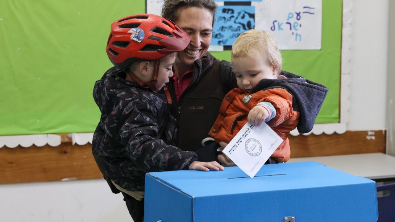 An Israeli woman casts her vote in Jerusalem in municipal elections that may offer a gauge of the public mood nearly five months into the Gaza war