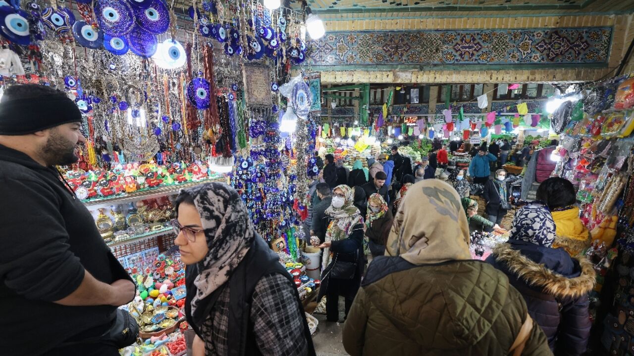 Shoppers throng a Tehran market as they prepare to mark the Nowruz Persian New Year amid economic woes in Iran