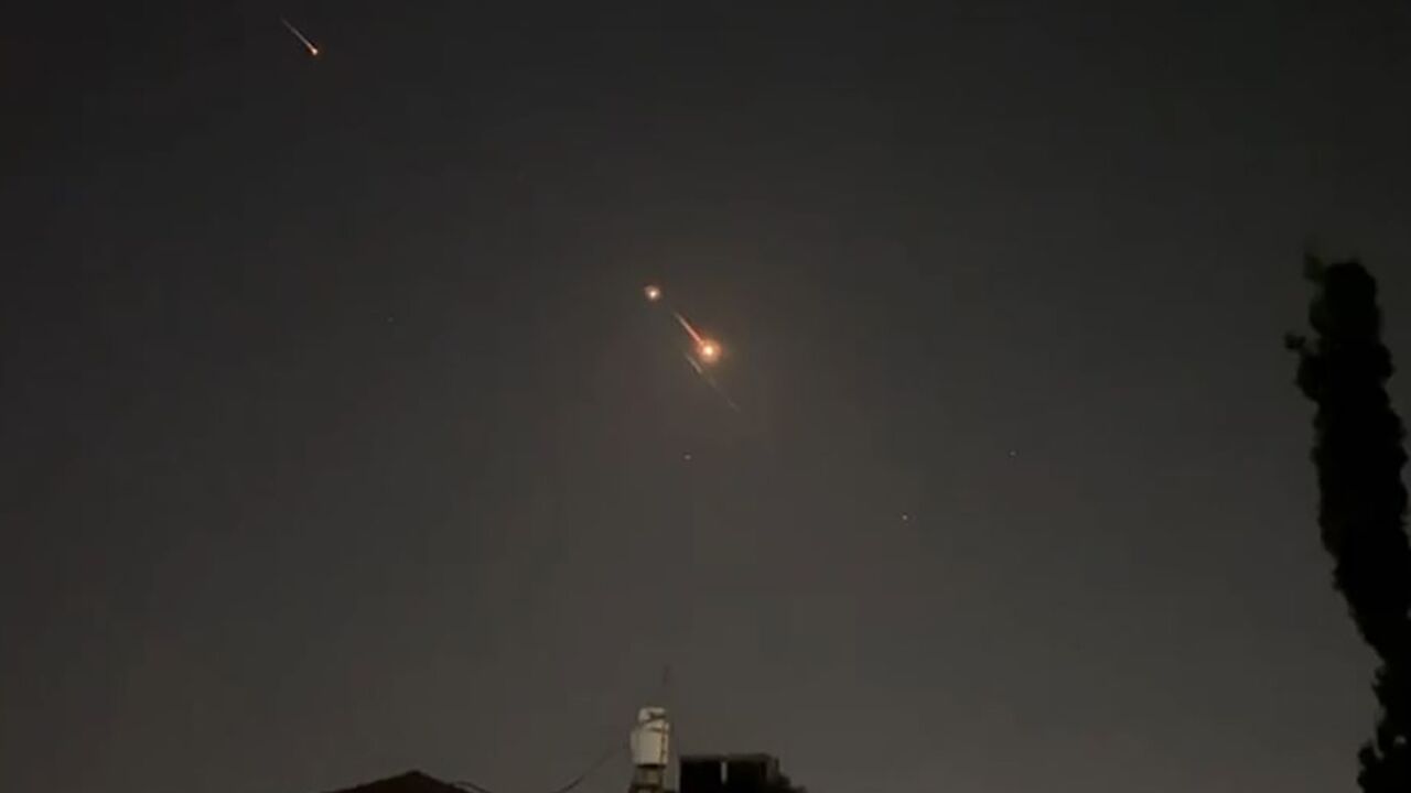 Explosions light up the sky over Jerusalem as Israeli air defences intercept incoming Iranian missiles and drones
