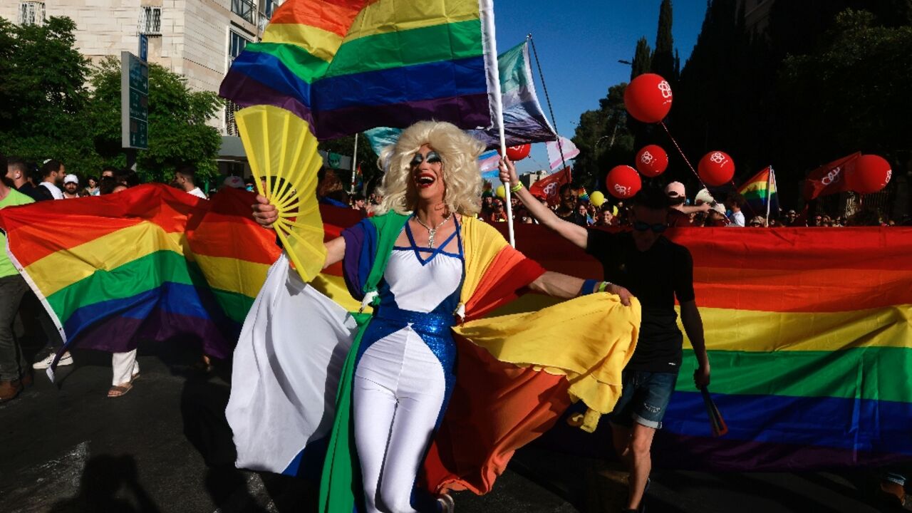 Rainbows and yellow ribbons mingle at Jerusalem Pride as marchers call for gay rights and the release of hostages held in Gaza at an event clouded by the war in Gaza