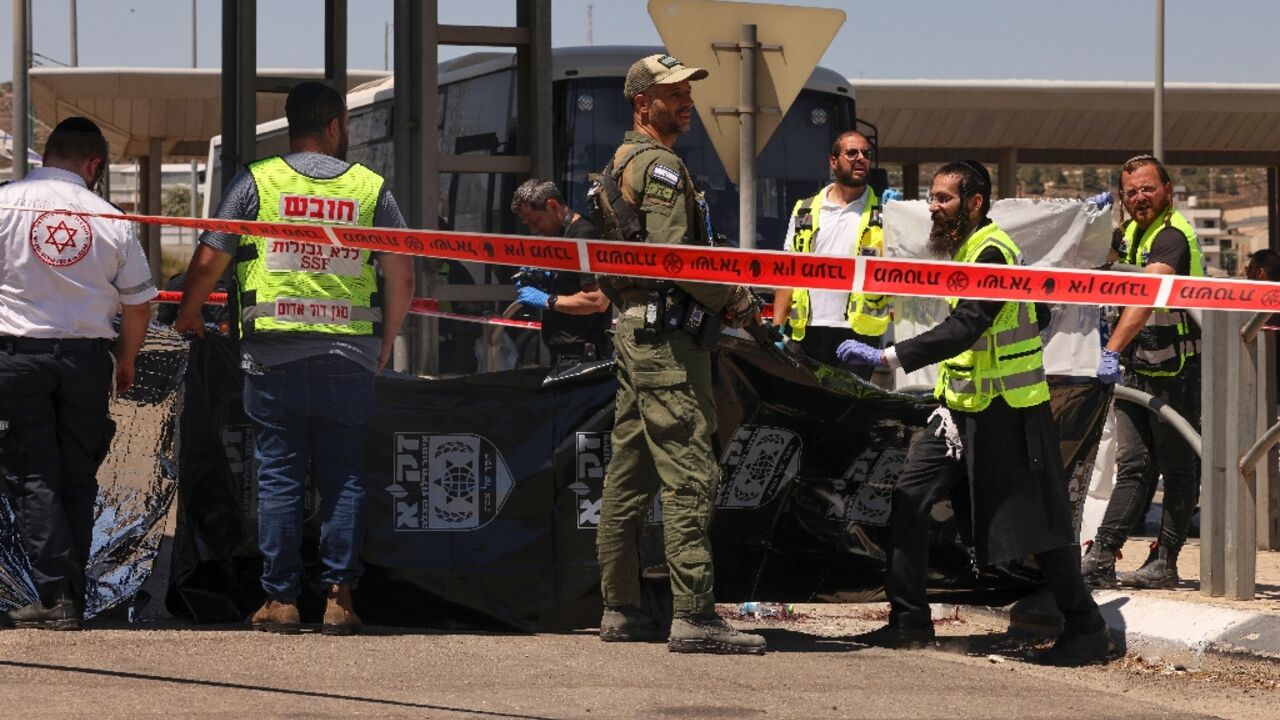 Israeli troops and medics respond after a Palestinian is shot dead at a checkpoint outside Jerusalem following an alleged stabbing attack on a border police officer