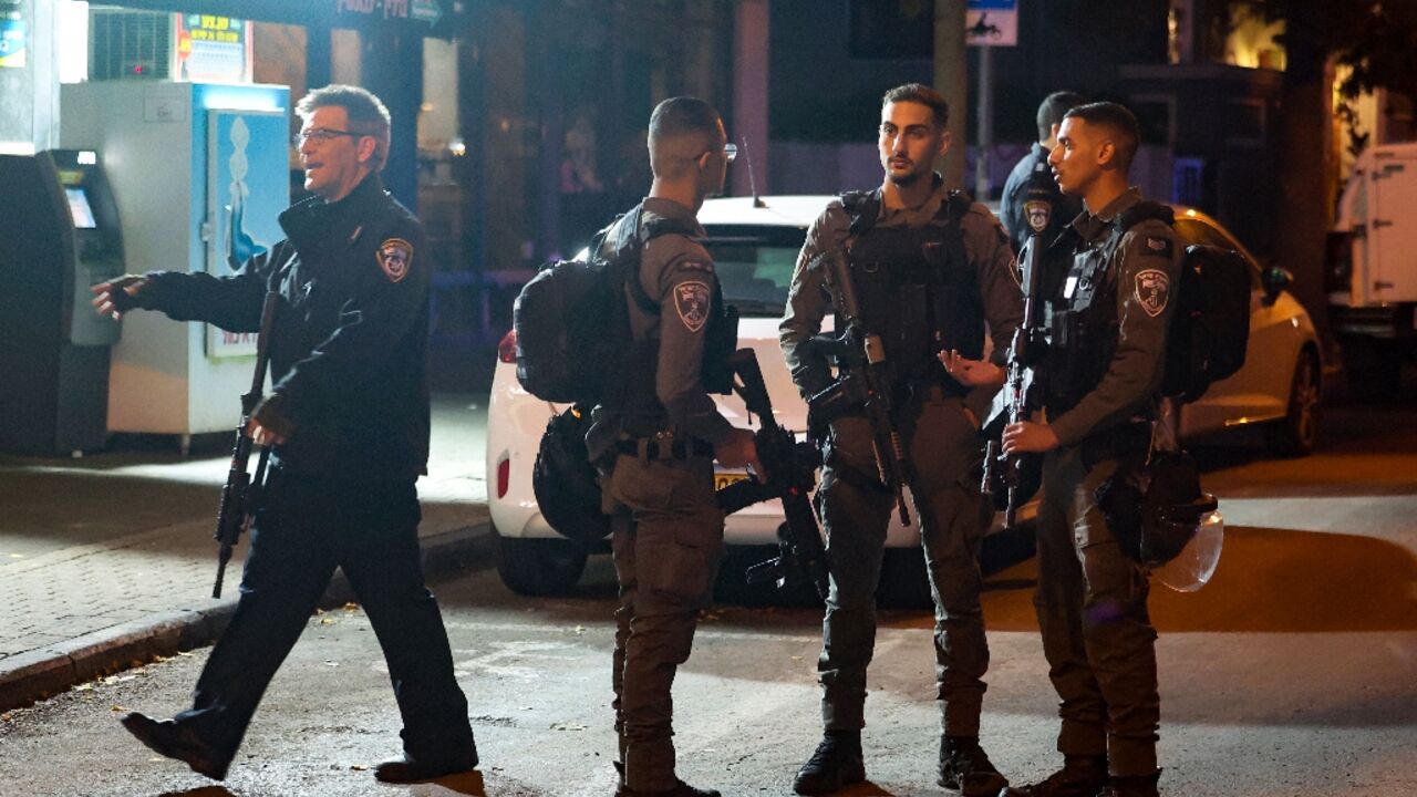 Israeli security forces stand guard at the scene of a Tel Aviv stabbing which wounded one person on the eve of the start of a Gaza truce.