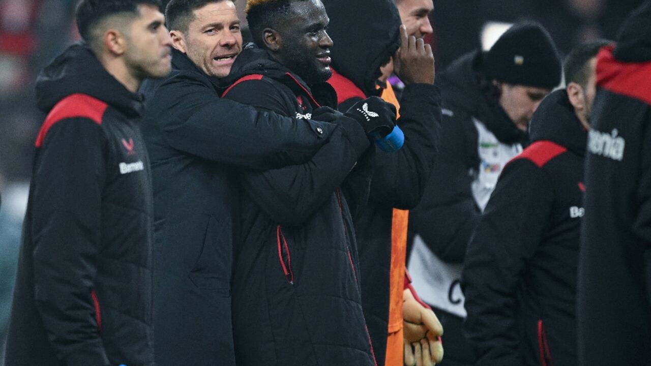 Bayer Leverkusen coach Xabi Alonso embraces striker Victor Boniface after he scored the winner in a 3-2 extra-time German Cup quarter-final win over Cologne