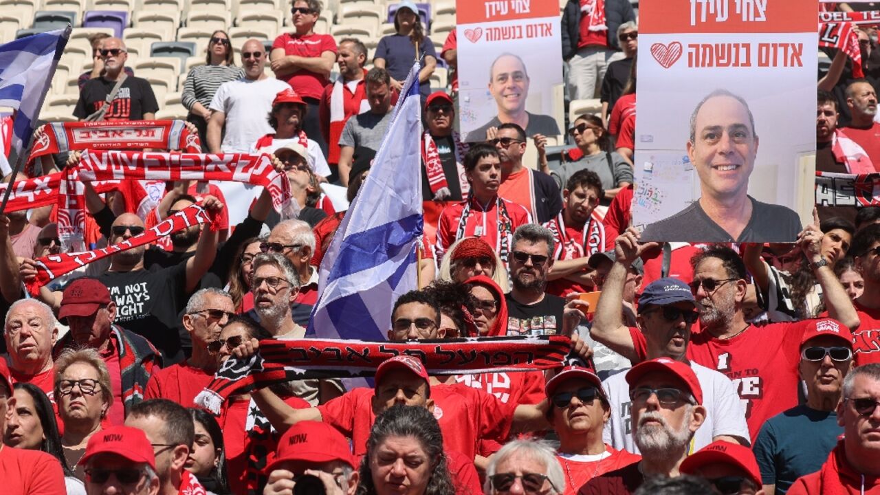 Hapoel Tel Aviv supporters gather in the club's Bloomfield Stadium to mourn fellow fan Tsachi Idan who was abducted to Gaza and died in captivity.
