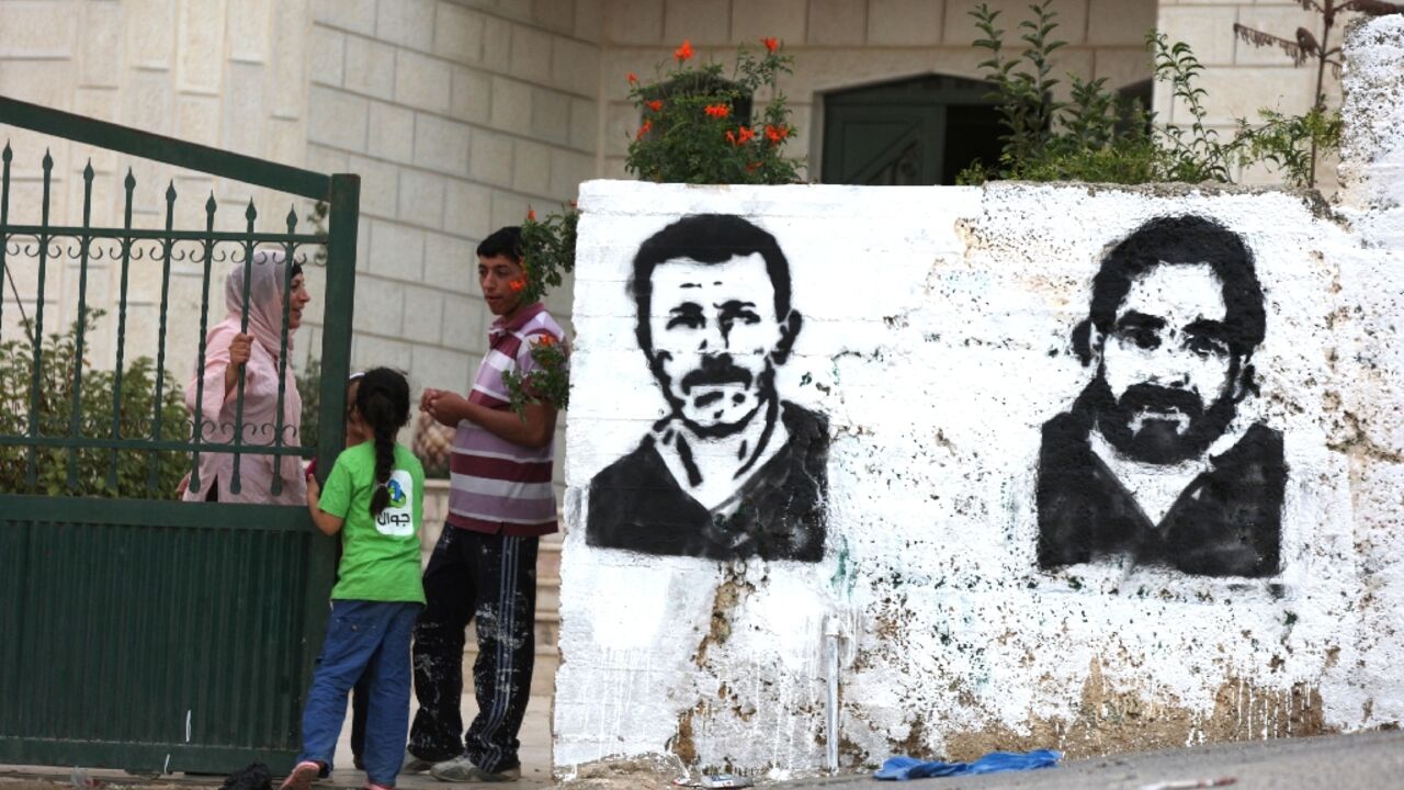 Graffiti of Nael Barghouti (L) and another long-serving Israeli prisoner Fakhri Barghouti, in the occupied West Bank village of Kubar on October 16, 2011