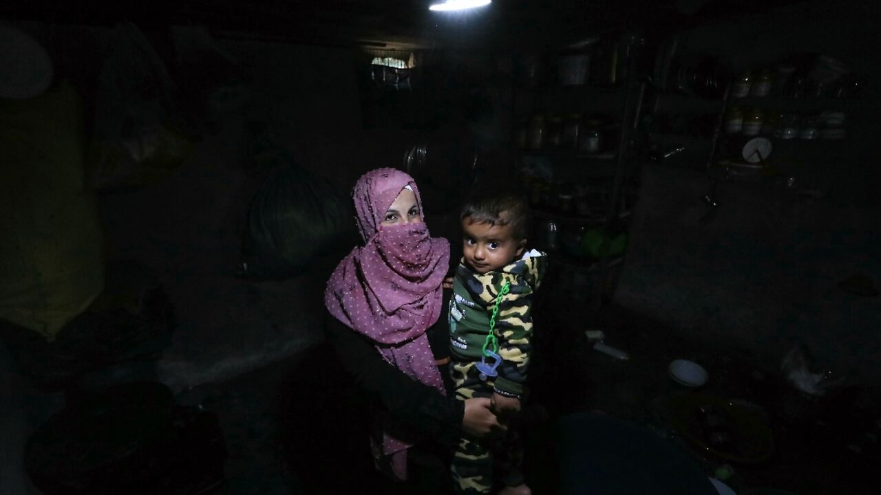 A woman and her baby in a tent at the Atme camp for displaced people in northwest Syria