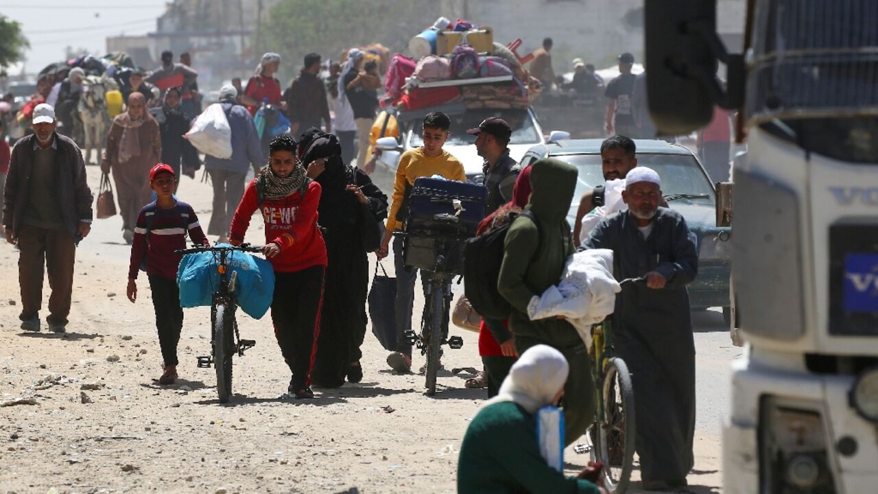 Residents flee Rafah by foot and by bike, while others push makeshift carts loaded with basic belongings after an Israeli evacuation order