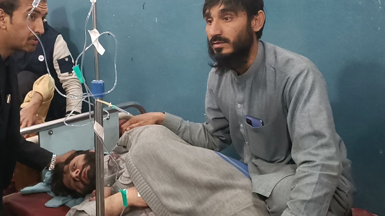 A man takes care of his injured relative in a hospital after the bomb blasts in Bannu