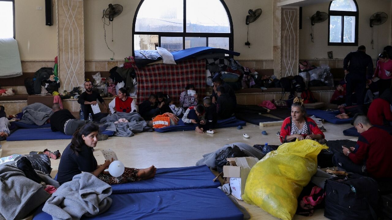 Syrians from the Alawite minority take shelter at a school in Lebanon's Masaoudiyeh village, after mass killings in their homeland