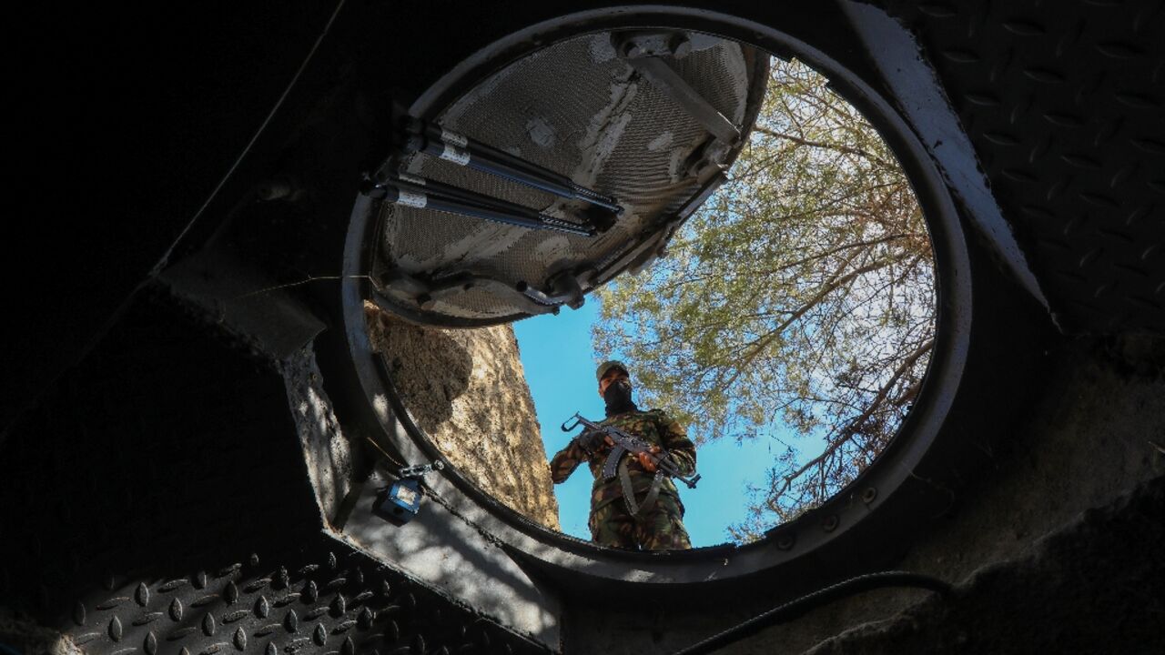 Mountain lair: a soldier looks into a hidden exit from from Maher al-Assad's private office built into a hilltop overlooking Damascus