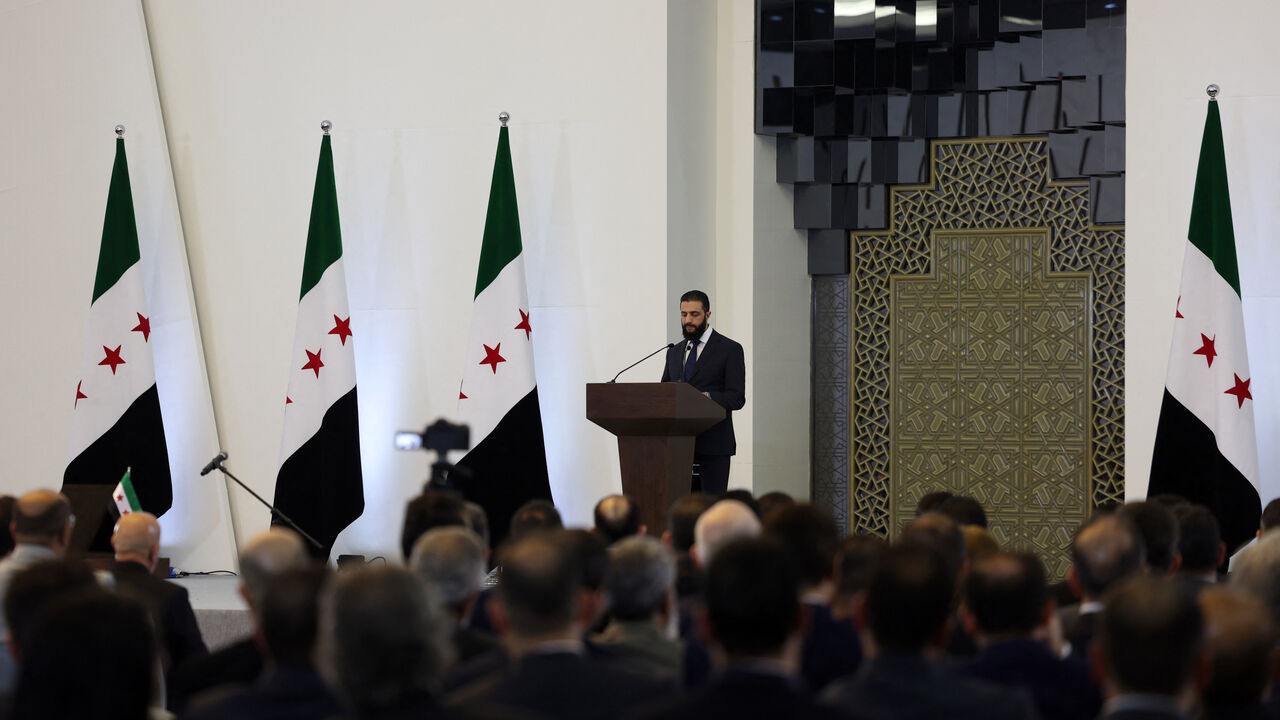 Syria's interim President Ahmed al-Sharaa delivers a speech in Damascus on March 29, 2025. Sharaa on March 29 announced a new transitional government dominated by close allies and including one woman, replacing caretaker authorities in place since the ouster of longtime ruler Bashar al-Assad. (Photo by OMAR HAJ KADOUR / AFP) (Photo by OMAR HAJ KADOUR/AFP via Getty Images)