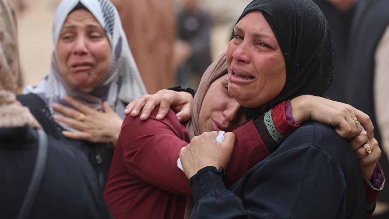 Palestinians mourn during a funeral of relatives killed in an Israeli strike on a school-turned-shelter at the Al-Shifa hospital in Gaza City 