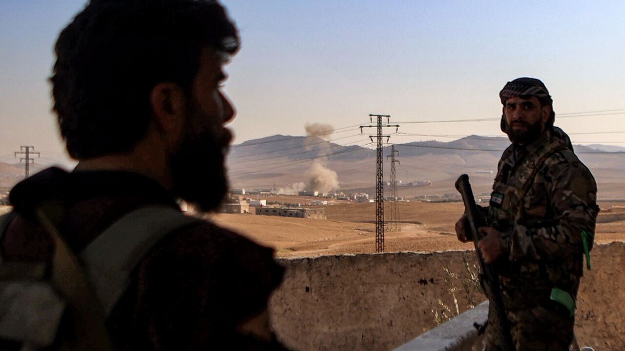 Turkish-backed Syrian fighters bombard Kurdish positions around Tishrin dam in January. They are now expected to pull back from the area under a deal between the Kurds and Damascus.