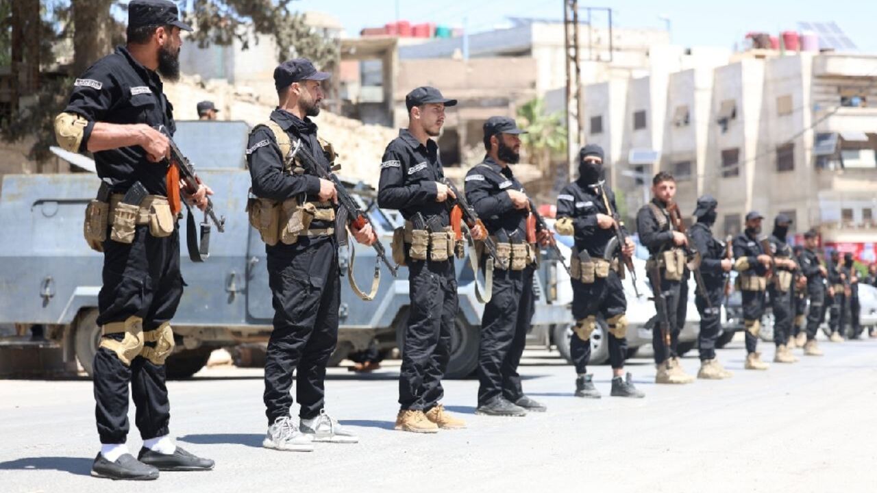 This handout picture released by the Syrian Interior Ministry Facebook page shows Syria's security forces standing guard in a street in the mostly Druze and Christian Jaramana suburb of Damascus