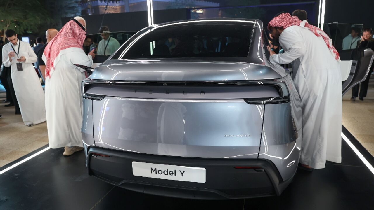 Saudis check a car at the Tesla company's first showroom in Riyadh. Elon Musk's firm has opened three showrooms in oil rich Saudi Arabia