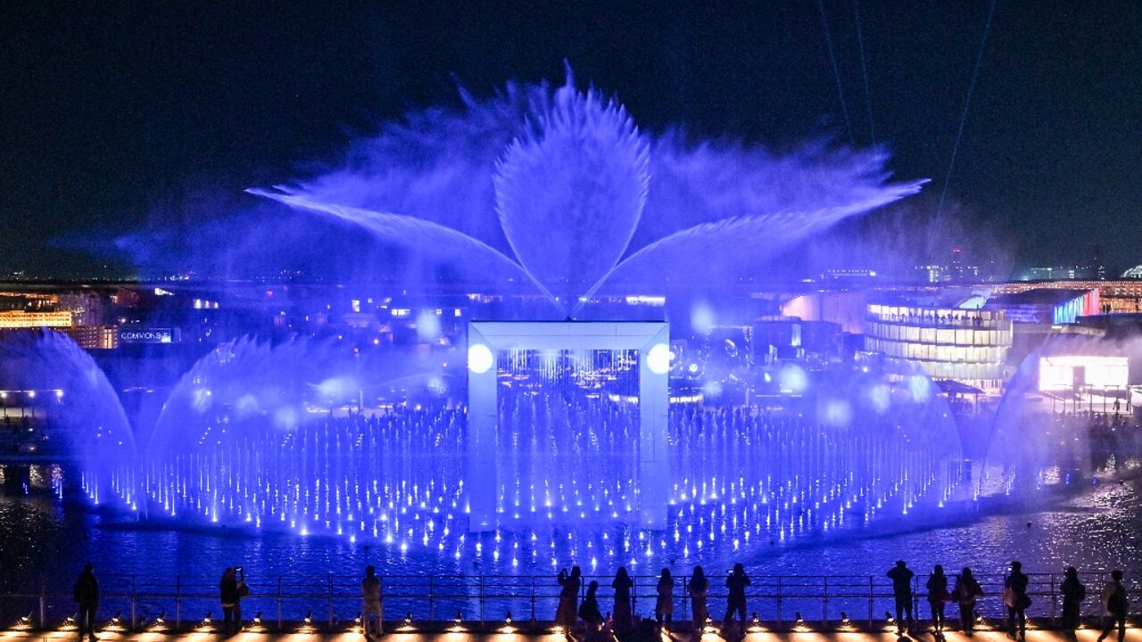 Visitors watch a water and light display during a media preview day for the 2025 Osaka Expo in Osaka on April 9, 2025