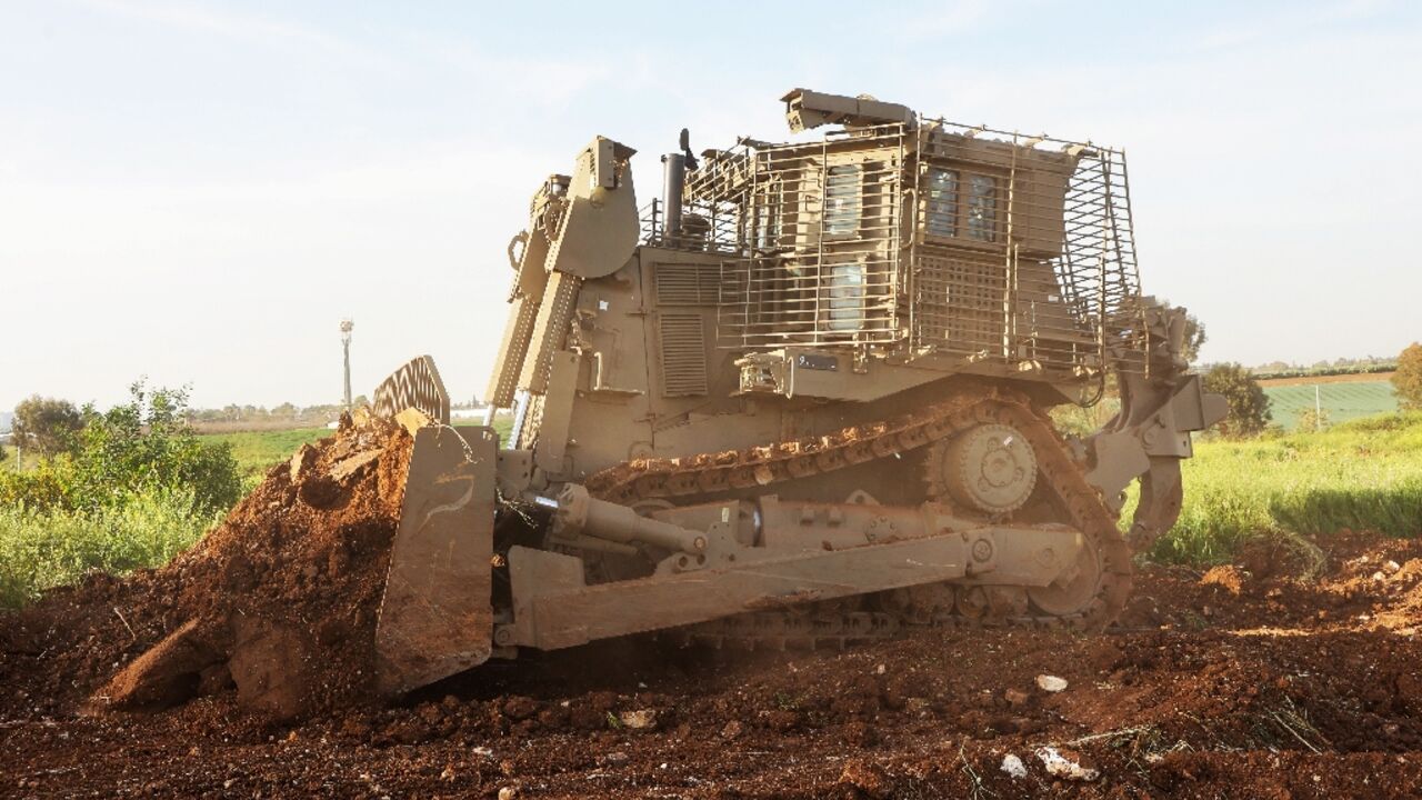 An unmanned D9 bulldozer digs up a field during a demonstration to the press at the Israel Aerospace Industries headquarters