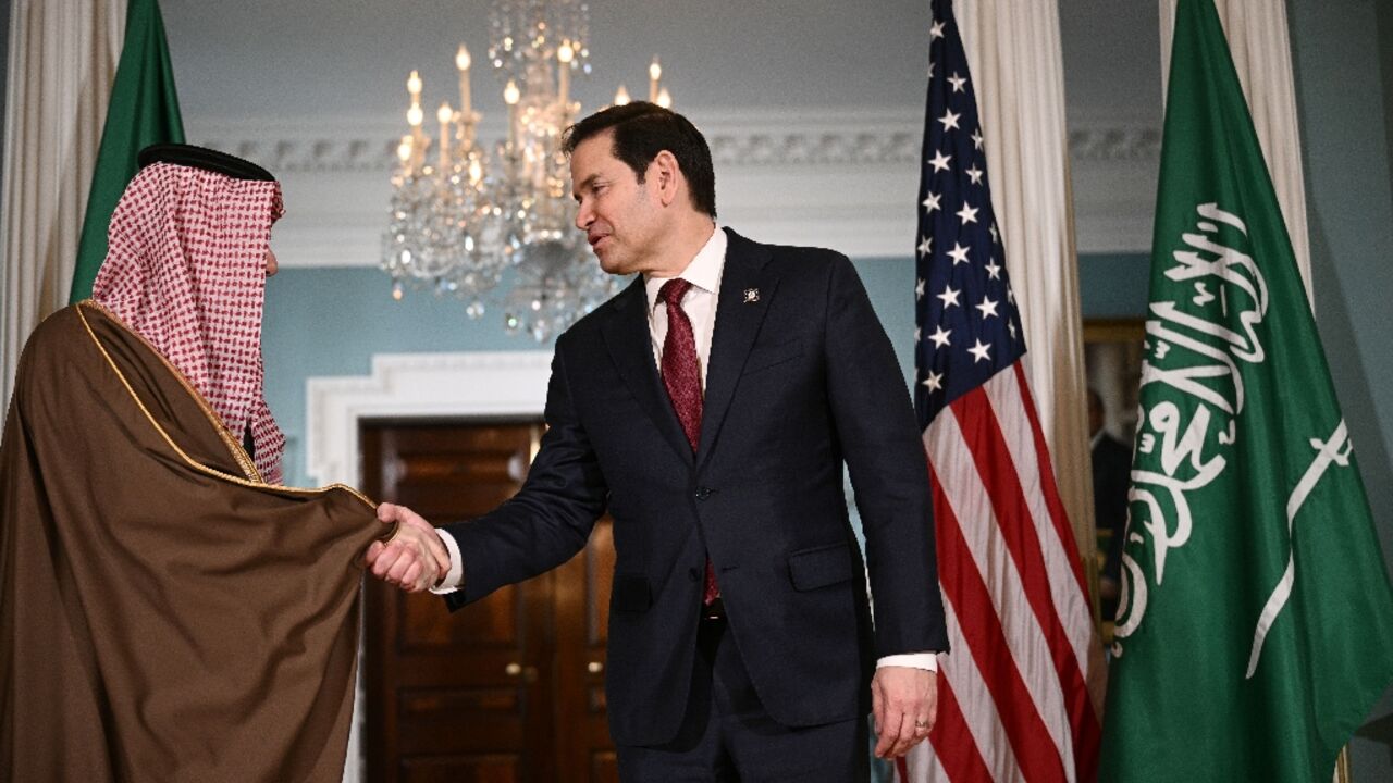 US Secretary of State Marco Rubio shakes hands with Saudi Arabia's Foreign Minister Prince Faisal bin Farhan al-Saud at the State Department 