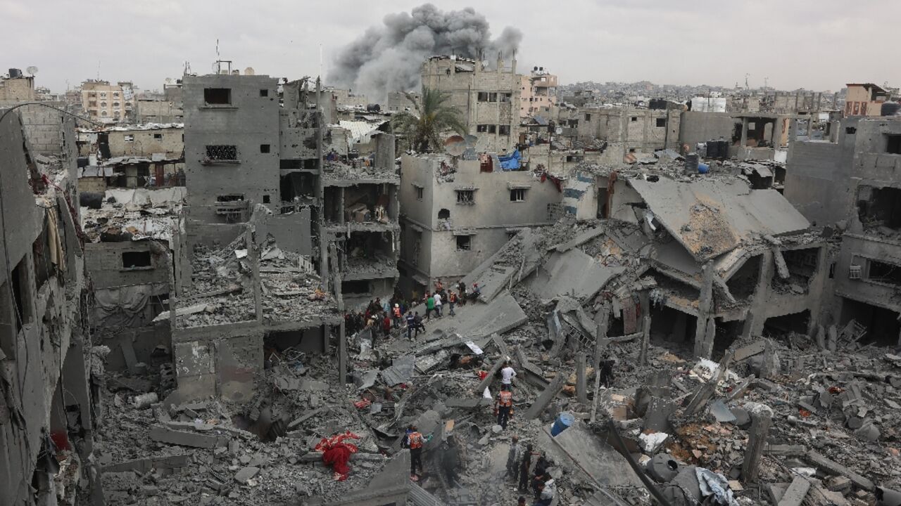 Palestinian rescuers search the rubble of a four-storey residential block in Gaza City for survivors after it was flattened by an Israeli strike, killing at least 23 people, according to the civil defence agency.