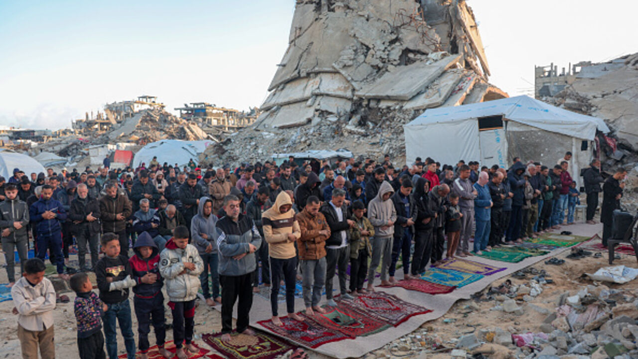 Palestinian Muslims say their Eid al Fitr prayers among the rubbles in Jabalia camp, north of the Gaza Strip on March 30, 2025. (Photo by Abood Abusalama / Middle East Images / Middle East Images via AFP) (Photo by ABOOD ABUSALAMA/Middle East Images/AFP via Getty Images)