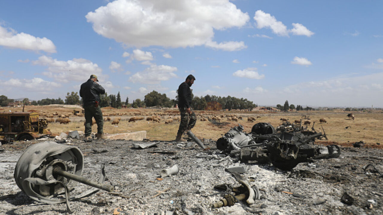 Men check the scene of an Israeli strike in Syria's southern Hama governorate, on April 3, 2025. (ABDULAZIZ KETAZ/AFP via Getty Images)