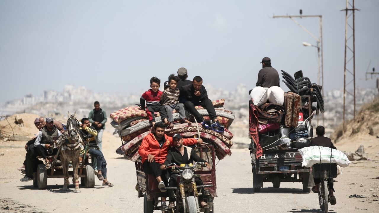 Palestinians heading south along a coastal road from Gaza City, as Israel expands operations in the north